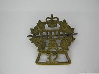 Front view of vintage Canadian Post Office badge with crown, maple leaves, 'CPO', and '32' number.