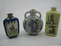 Three Chinese vintage porcelain bottles side by side showing their shapes and colors.