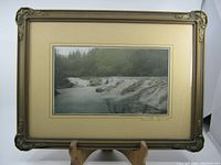Full view of framed photograph showing the waterfall scene and frame condition.