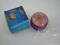 Light Yo Yo toy and its original box, showing toy details and string attached