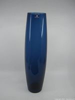 Front view showing the full height and smooth surface of the blue glass vase.