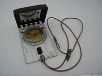 Full view of the Silva Type 15T The Ranger compass showing the clear base plate, compass dial with rotating bezel, sighting mirror open, and attached brown cord.