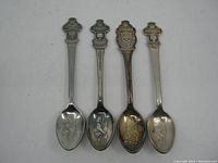 Four vintage Rolex souvenir spoons laid side-by-side from handle top to bowl, showing wear and tarnish variations.