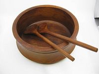 Round teak wood salad bowl with two matching serving utensils inside showing overall condition.