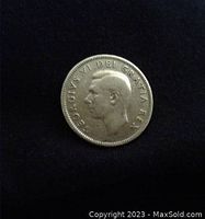 Obverse side of the 1949 Canadian quarter showing King George VI profile and inscription.