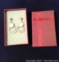 Pair of 925 silver and mother of pearl drop earrings in red gift box with lid.