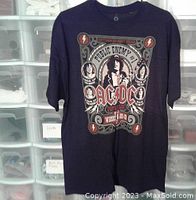 Front full view of black AC/DC Public Enemy No.1 T-shirt hanging, showing full graphic design.