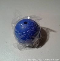 Blue silicone spherical mold wrapped in plastic