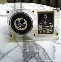 Acrylic display with Toronto Maple Leafs puck on the left and Grant Fuhr hockey card on the right.