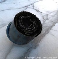 Top view of the hole saw drill bit set showing multiple toothed bits coiled in a spiral.