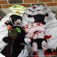 Group photo of the four Kindergoth Kids plush dolls showing their size, color, and overall condition