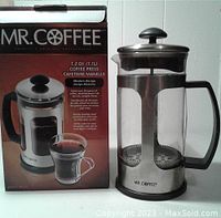 Photo showing the Mr. Coffee branded coffee press next to its original packaging box with product details.