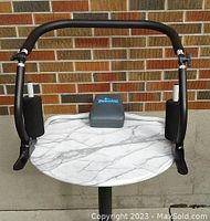 Front view of Perfect Abs sit-up training device showing black metal frame, foam hand grips, and leg cushions.