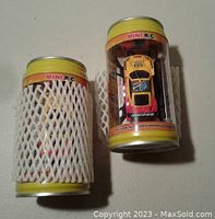 Two mini remote control cars packaged to resemble soda pop cans, one with protective netting