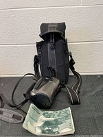 Photo of Canon PHOTURA camcorder, carrying case, and user manual displayed on a table.