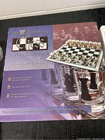 Box for the drinking chess game showing glass playing board and 32 shot glasses included.