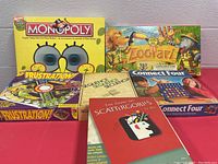 Photo of 5 board games showing Monopoly SpongeBob, Frustration, Zoo Clues, Scattergories, Connect Four boxes.