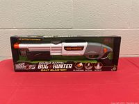 Photo of boxed Bug Hunter Double Barrel Salt Blaster bug gun from Air Warriors, showing front of packaging with product name and size visible.