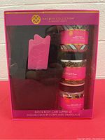 Photo of gift box showing slippers and three body care products.