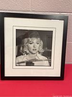 Framed 17x17 black and white photograph of Marilyn Monroe, full view showing frame and mat.