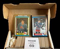Box containing the stack of hockey cards with rookie cards of Joe Sakic and Brian Leetch prominently showing in front.