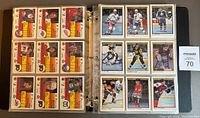 Binder pages holding the complete set of 132 hockey cards from the 1990-91 O.P.C. Premier series, showing multiple cards visible in nine-pocket pages including team and player details.