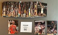 Stack of trading cards arranged on surface, showing the large quantity of the series 2 set. Michael Jordan and Shaquille O'Neal cards laid out in front of stack for display.