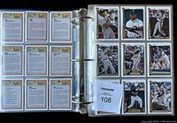 Binder open showing backs of Upper Deck cards neatly arranged in plastic sleeves