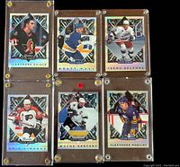 Front view showing six hockey cards featuring Alexandre Daigle, Brett Hull, Teemu Selanne, Eric Lindros, Wayne Gretzky, and Alexander Mogilny held in screwdown lucite holders.