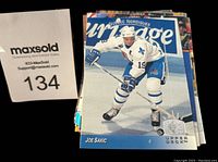 Photo shows a portion of the hockey card set with the card featuring Joe Sakic in Quebec Nordiques white uniform, holding a hockey stick on ice, visible with Upper Deck and SP logos.