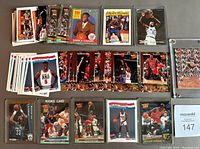 Overview of assorted basketball cards laid out including multiple USA team cards, Derrick Coleman, Dikembe Mutombo, Michael Jordan and Scottie Pippen cards