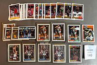 Photo of basketball trading cards laid out showing a variety of cards including Beam Team cards, Michael Jordan and Shaquille O'Neal cards, with some in protective sleeves and others loose.