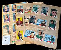 Photo of scrapbook pages showing multiple 1960s OPC hockey cards from various teams including Flyers, Seals, Kings