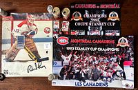 Full lot overview photo showing autographed Patrick Roy poster, two Stanley Cup celebration posters, two Molson Export cans, and several smaller items.