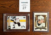 Front view of two Sidney Crosby hockey cards in protective cases, one in action pose and one portrait.