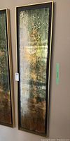 Full vertical view of abstract metal panel art showing the entire artwork with resin and textured paint in green, gold, brown and white shades in a black frame.