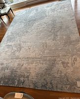 Full overhead view of rug on hardwood floor showing overall pattern and dimensions