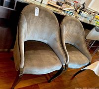 Two dining chairs side by side under countertop