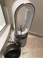Front view of Dyson hot and cool fan heater and Honeywell portable fan