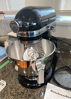 Mixer assembled with bowl and attachments on countertop