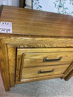 Front and side view showing natural wood grain, dovetail joinery drawers, and brass-style handles on night table.