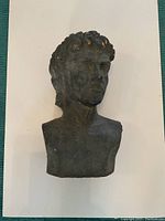 Front view of the bust sculpture on a white background showing entire bust.