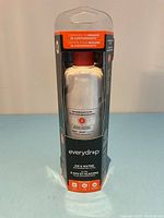Front view of new unopened Everydrop refrigerator water filter #2 in clear plastic packaging showing the white filter with red top and branding details.