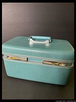 Closed view of a blue Sears Courier vintage travel case showing the textured exterior and handle.