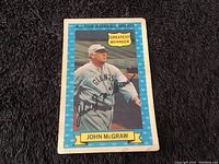 Front side of 1970 Topps All-Time Baseball Greats John McGraw card showing photo, autograph print, and name banner.