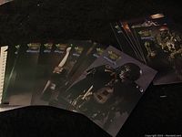 Twenty-eight collectible football cards showing NFL players as monsters, arranged in fanned out stack, dark football-themed design.