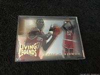 Front side of 1994 Hakeem Olajuwon Living Legends basketball card showing player in Rockets uniform in action poses.