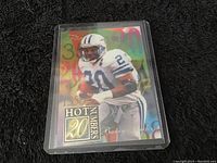 Front view of Barry Sanders collectible football card featuring player image, colorful numerical background, and Hot Numbers 20 label.