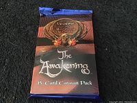 Front of sealed 'The Awakening' 15-card caravan pack from Legend of the Burning Sands collectible card game.