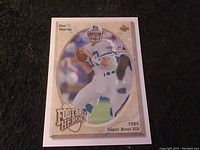 Front of the Dan Marino 1985 Super Bowl XIX Football Heroes collectible card showing action photo and branding.